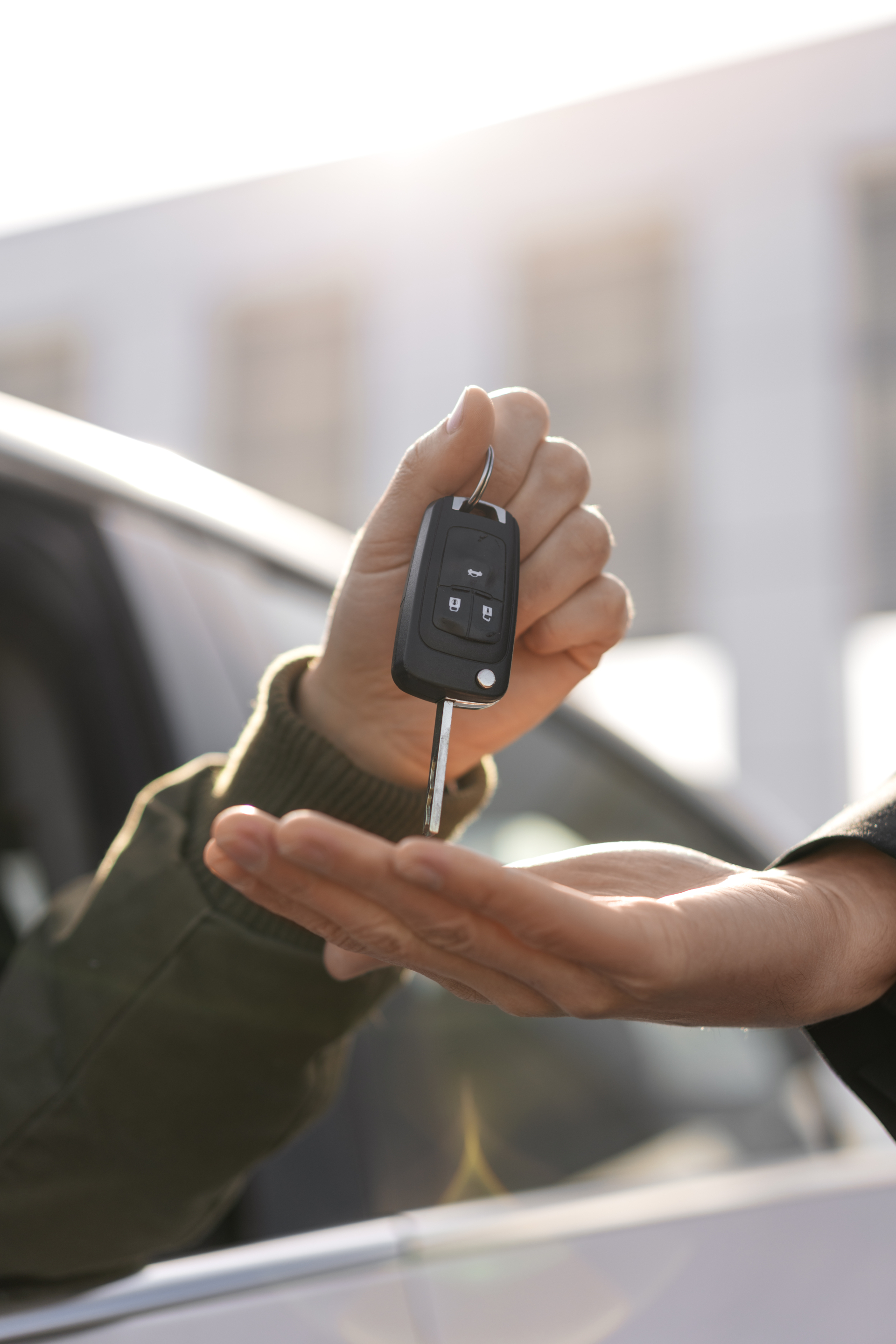 side-view-hands-holding-car-key